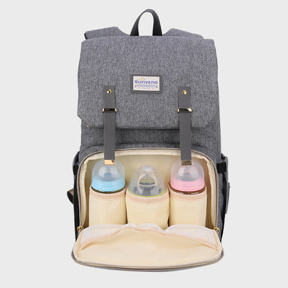 Canvas backpack opened at the front with three bottles standing in the insulated holders.