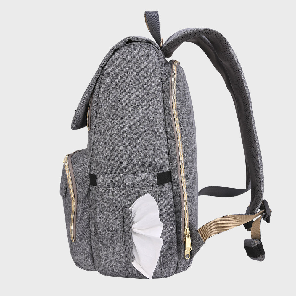 Tissue being pulled from the side dispenser pocket on the canvas backpack.