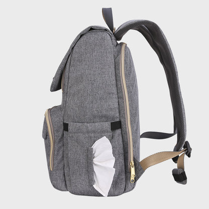 Tissue being pulled from the side dispenser pocket on the canvas backpack.