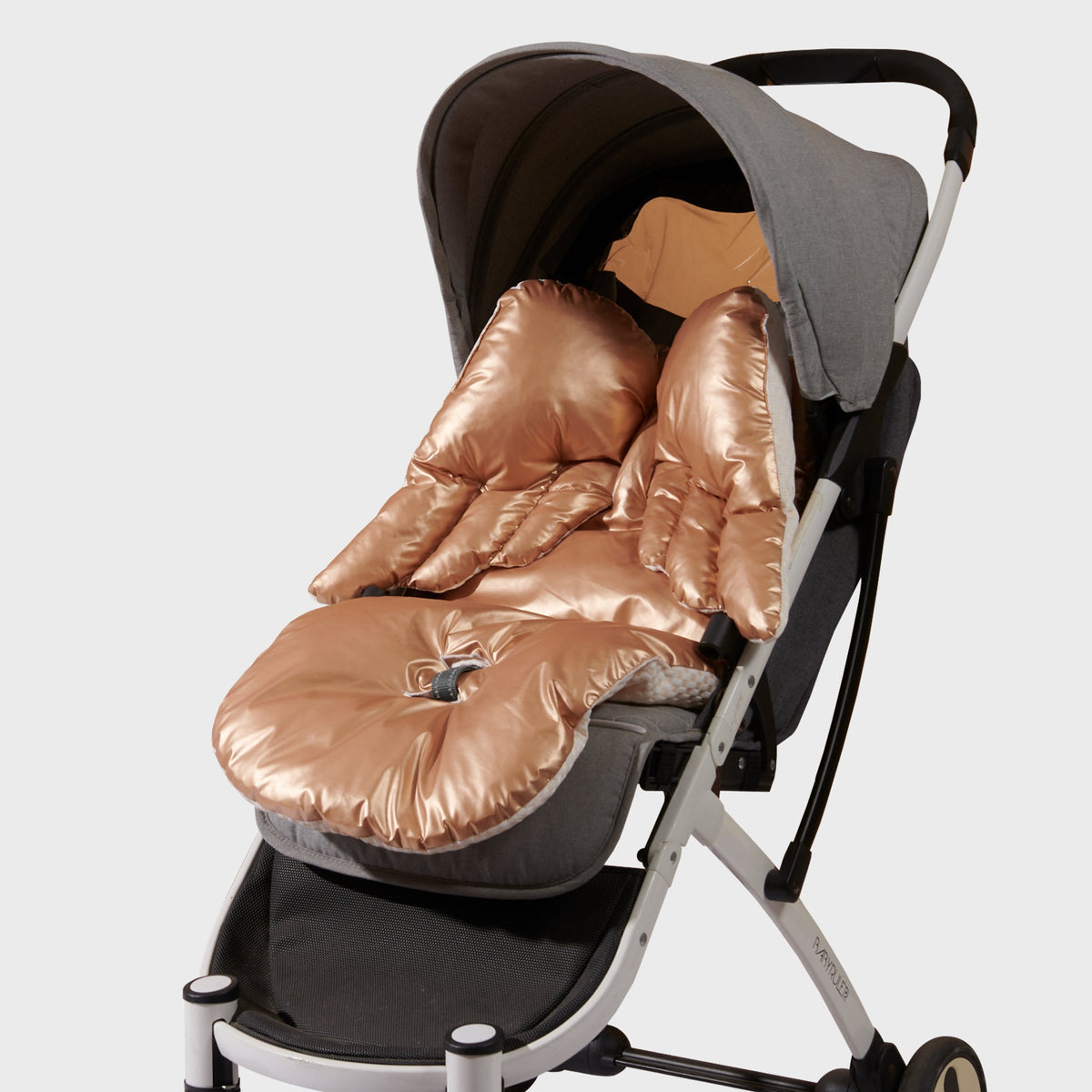 Gold stroller cushion with the angel wings attached, styled against clouds and stars.