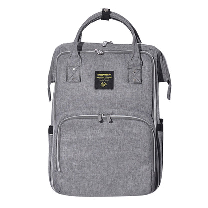 Structured diaper backpack with the insulated front pocket sized for three bottles.