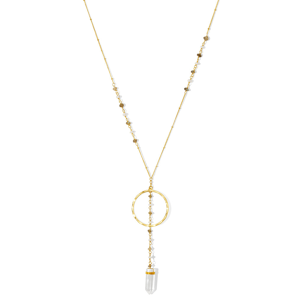 Clear quartz Y necklace on white, a beaded chain, a brass ring and a quartz point at the end