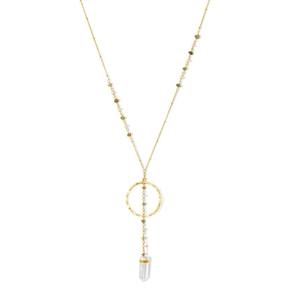 Clear quartz Y necklace on white, a beaded chain, a brass ring and a quartz point at the end