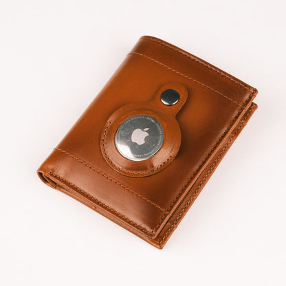 Leather AirTag wallet in tan, closed, with an AirTag held in the round snap pocket on the front