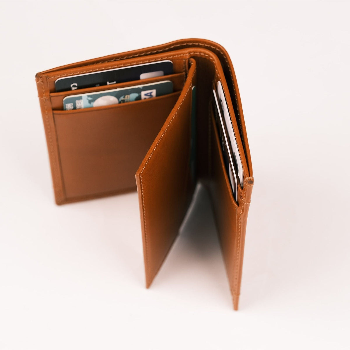 Tan AirTag wallet standing half open, showing the layered card pockets and inner flap