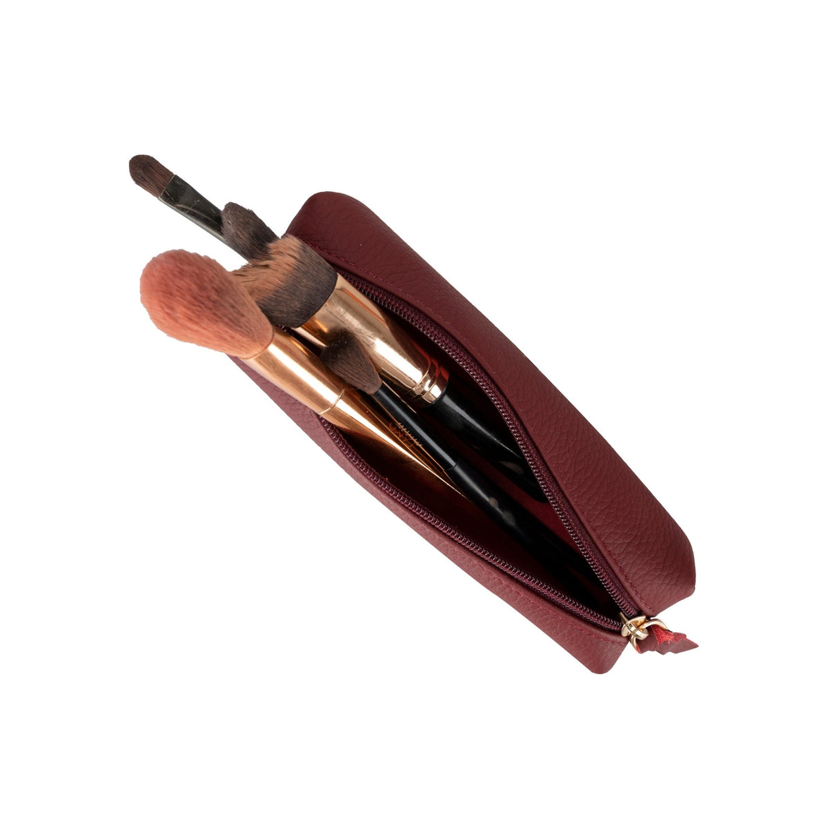 Maroon leather pouch holding makeup brushes, their tips rising out of the open zip