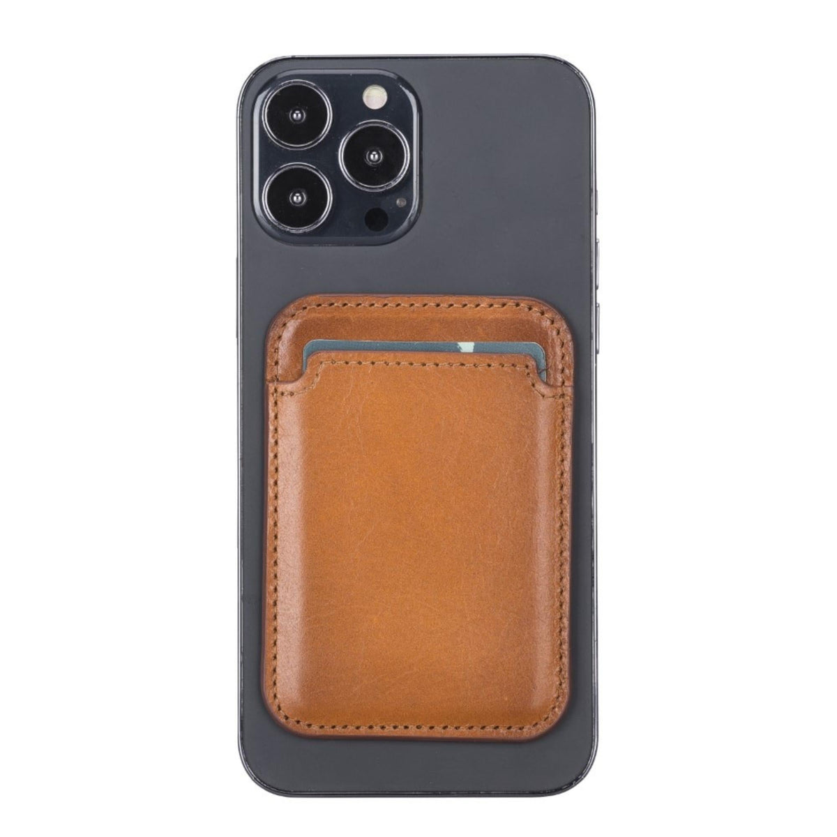 Magnetic leather card holder in tan attached to the back of a dark iPhone
