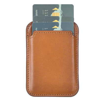 Tan full-grain leather card holder on its own, three cards rising out of the top opening