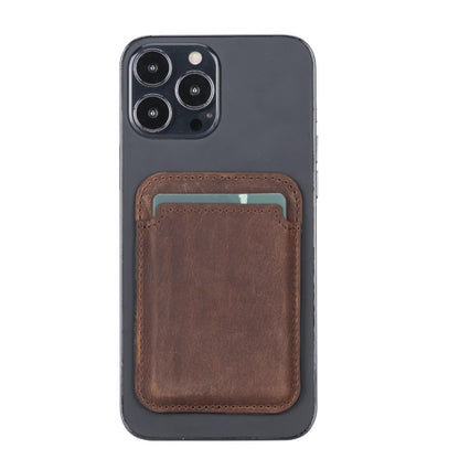 Magnetic leather card holder in dark brown on the back of an iPhone
