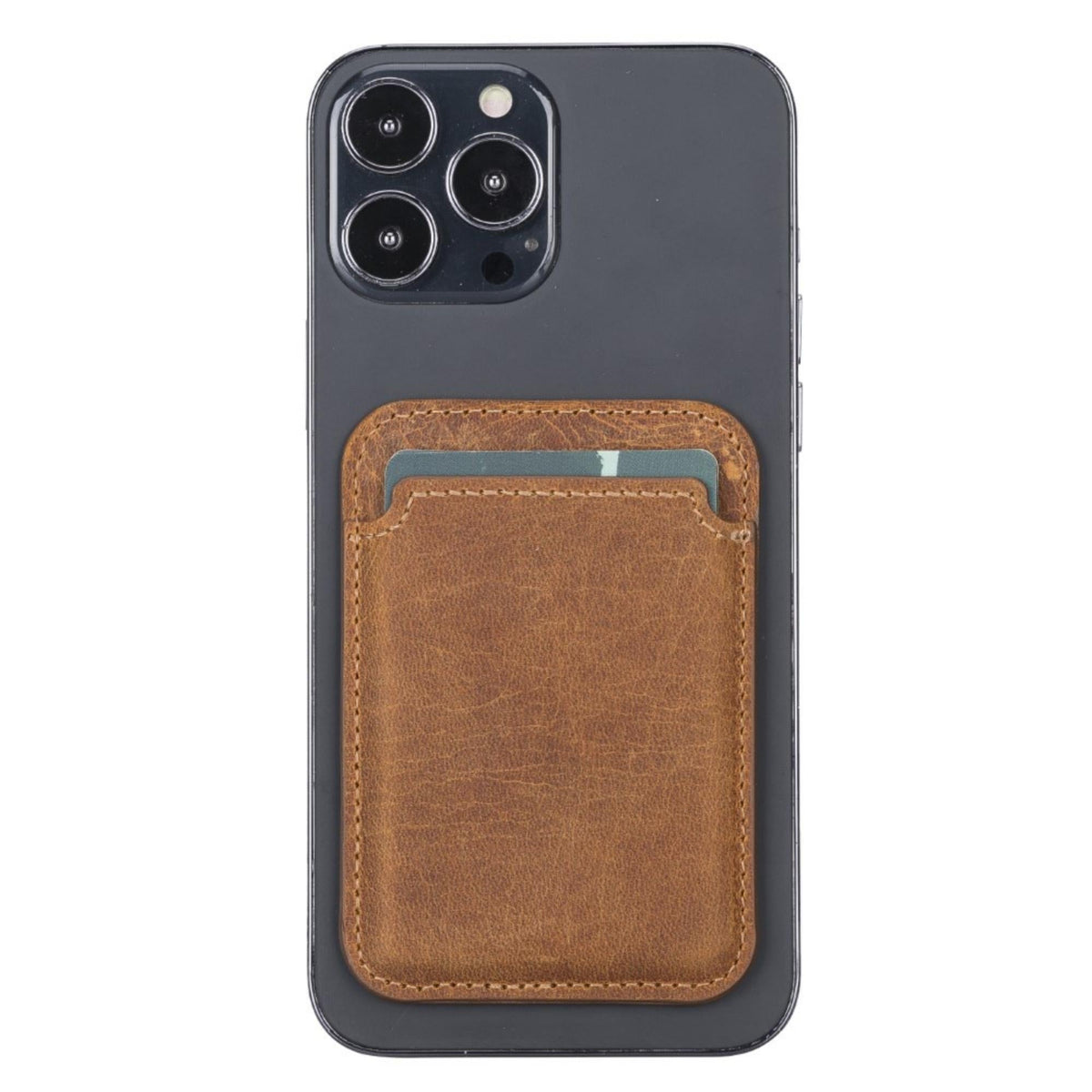 Magnetic leather card holder in Antic Tan, a mottled light brown, on the back of an iPhone
