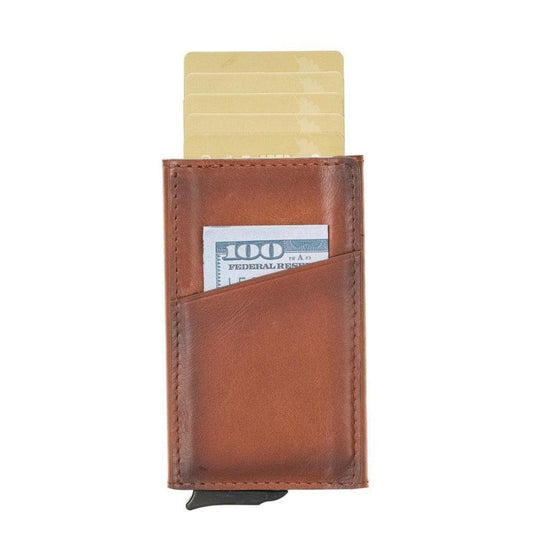 Slim pop up card holder in tan leather, cards raised out of the top and a bill in the front pocket