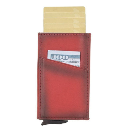 Pop up card holder in red leather with cards raised and a bill in the slanted front pocket