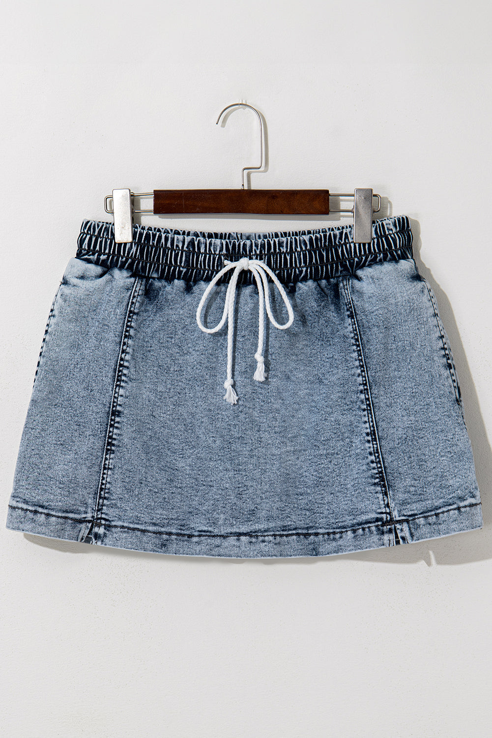 Blue acid wash denim skort on a hanger