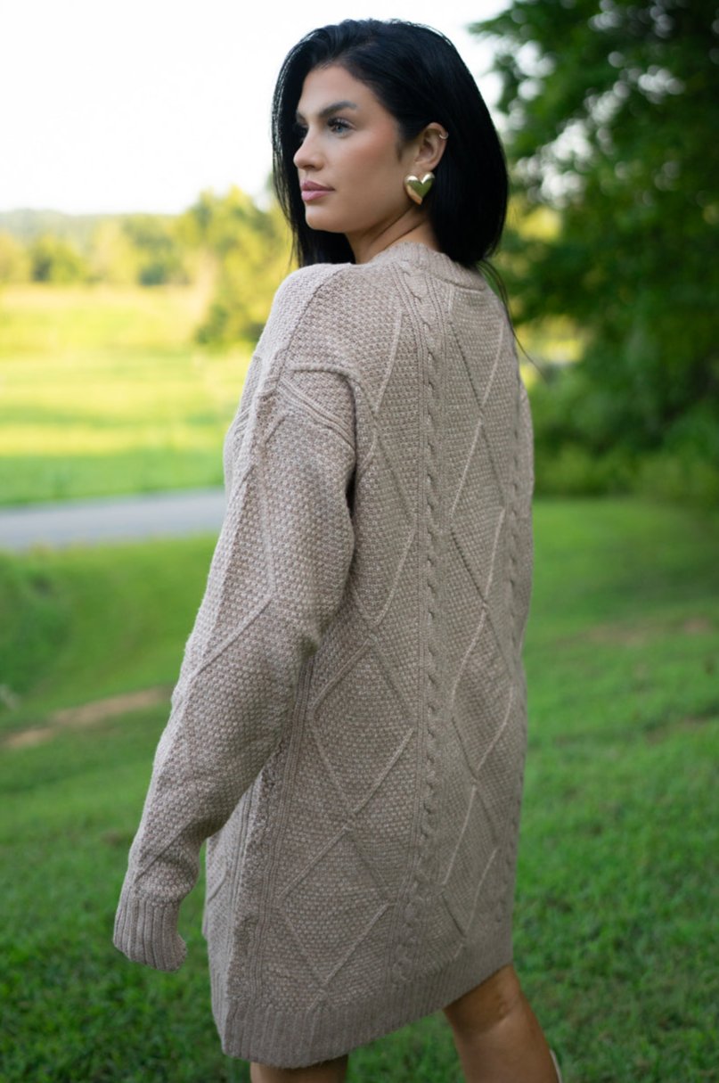 Back three-quarter view of the taupe cable knit sweater dress
