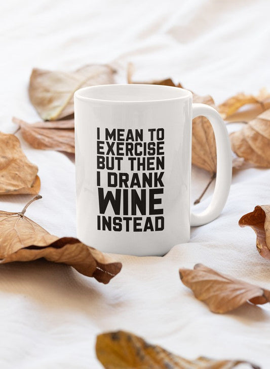 Women's ceramic exercise mug with artistic fall leaf design, styled on a white sheet.