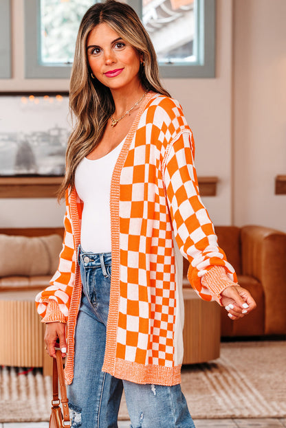 Three-quarter view of the open-front orange checkered cardigan