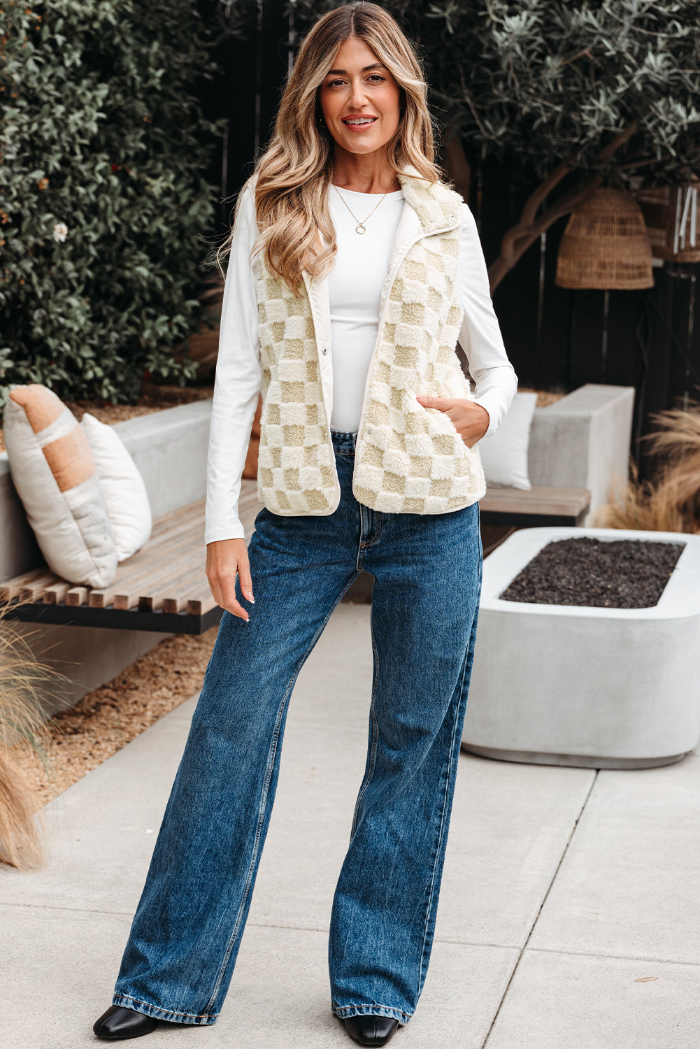 Full length view of the cream and tan sherpa vest with wide-leg jeans