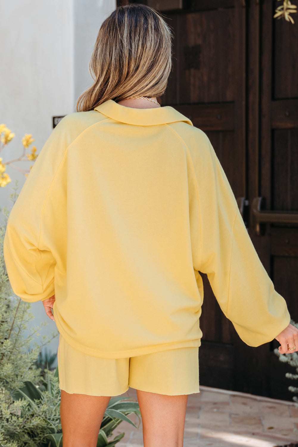 Back view of the pale yellow pullover and shorts set