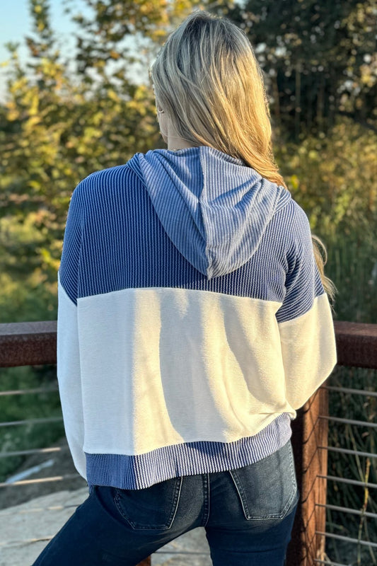 Back of the knit hoodie showing the blue hood and yoke