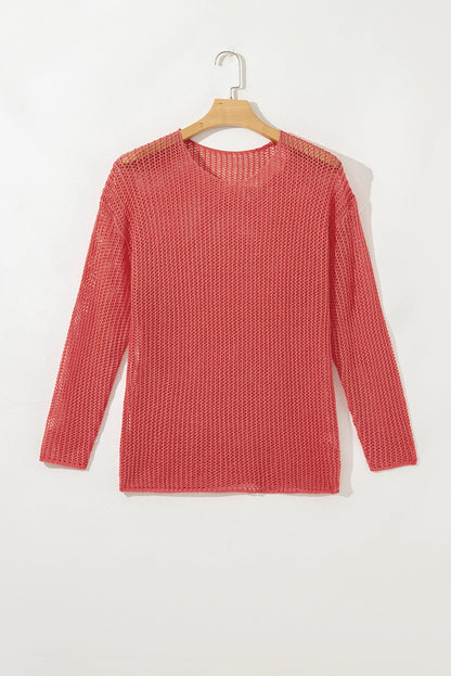 Coral crochet open-knit sweater on a hanger