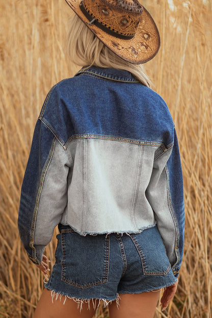 Back of the cropped denim jacket with a light wash panel and dark sleeves