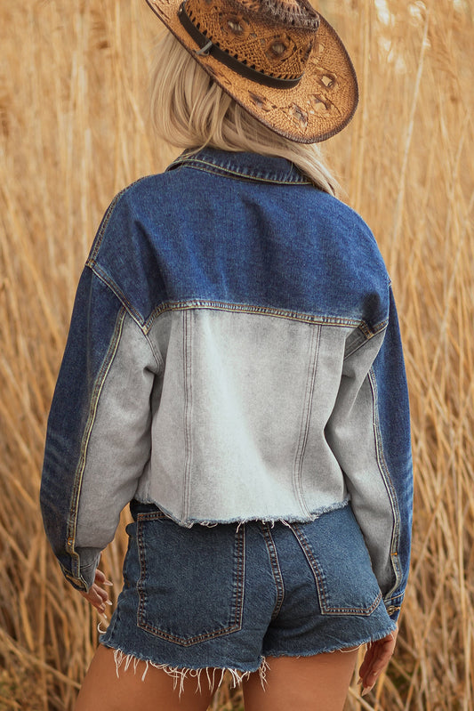 Back of the cropped denim jacket with a light wash panel and dark sleeves