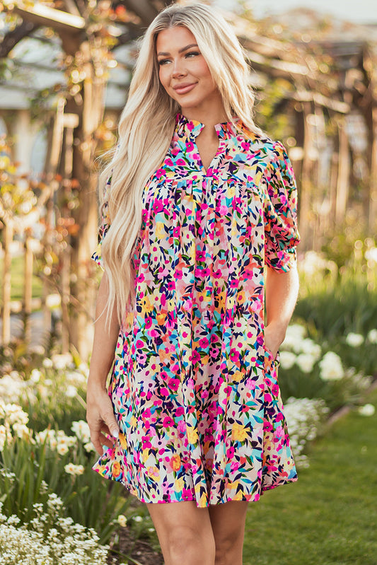 Hot pink ditsy floral mini dress with puff sleeves in a garden
