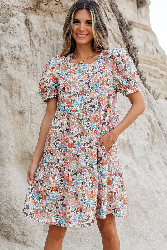 Apricot floral puff sleeve mini dress on a beach, front view