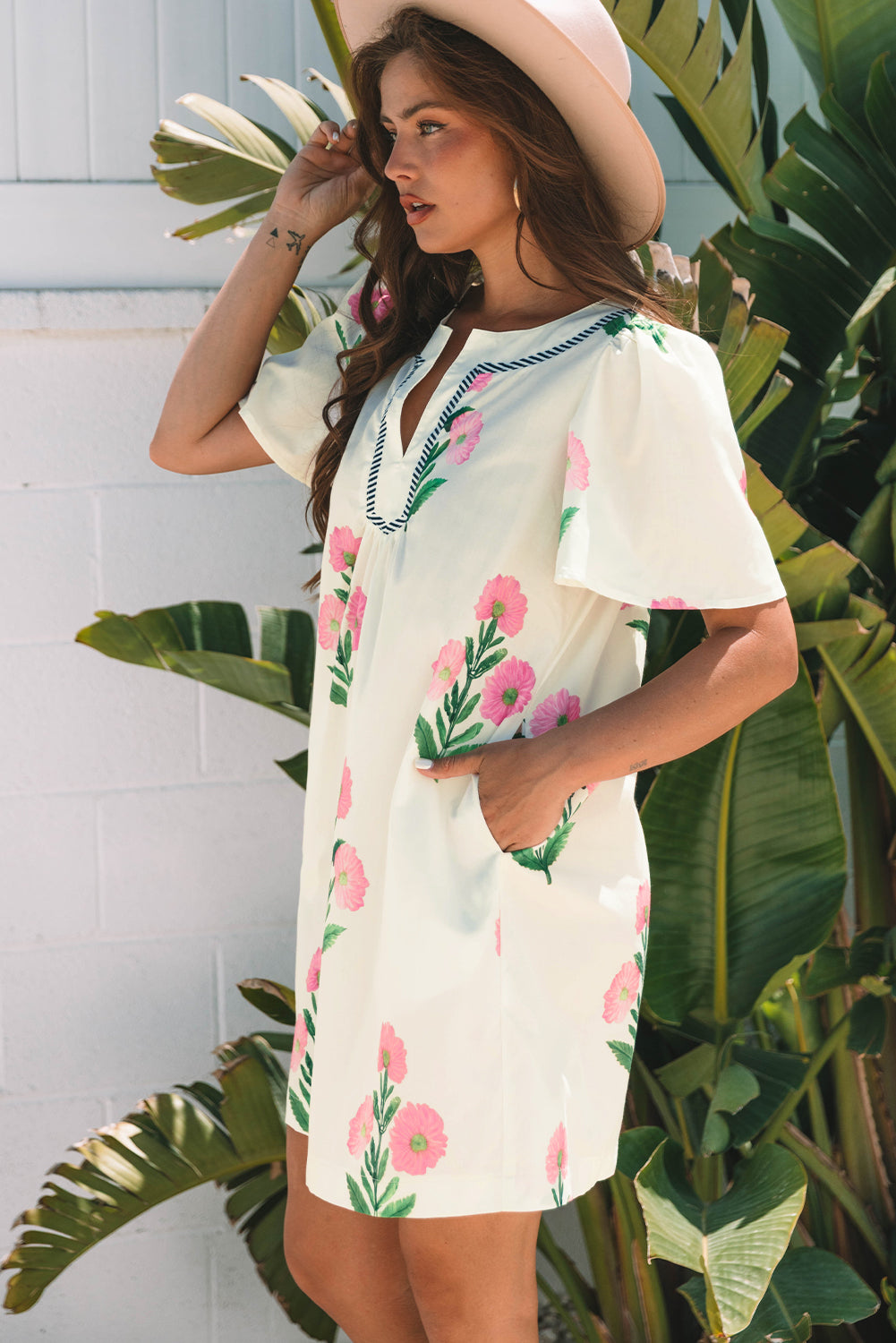 Cream floral shift dress, side view with a hand in the pocket
