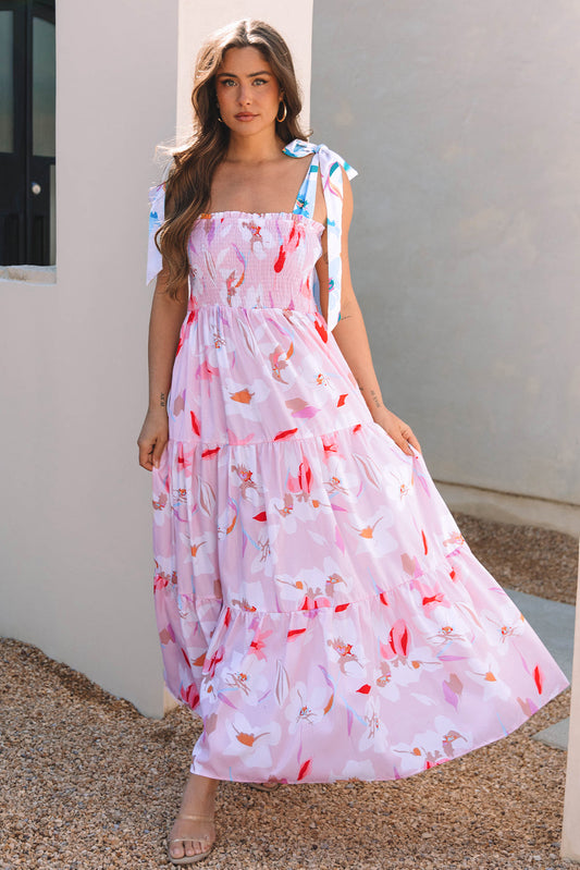 Pink floral tiered maxi dress with tie shoulder straps, model walking, front view