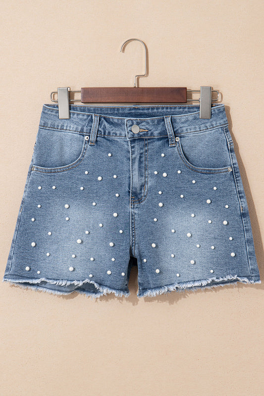 Medium wash denim shorts with scattered pearls on a hanger, front view