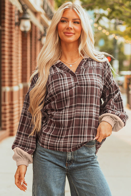 Brown plaid hooded top with a collar and half-button placket, worn with jeans
