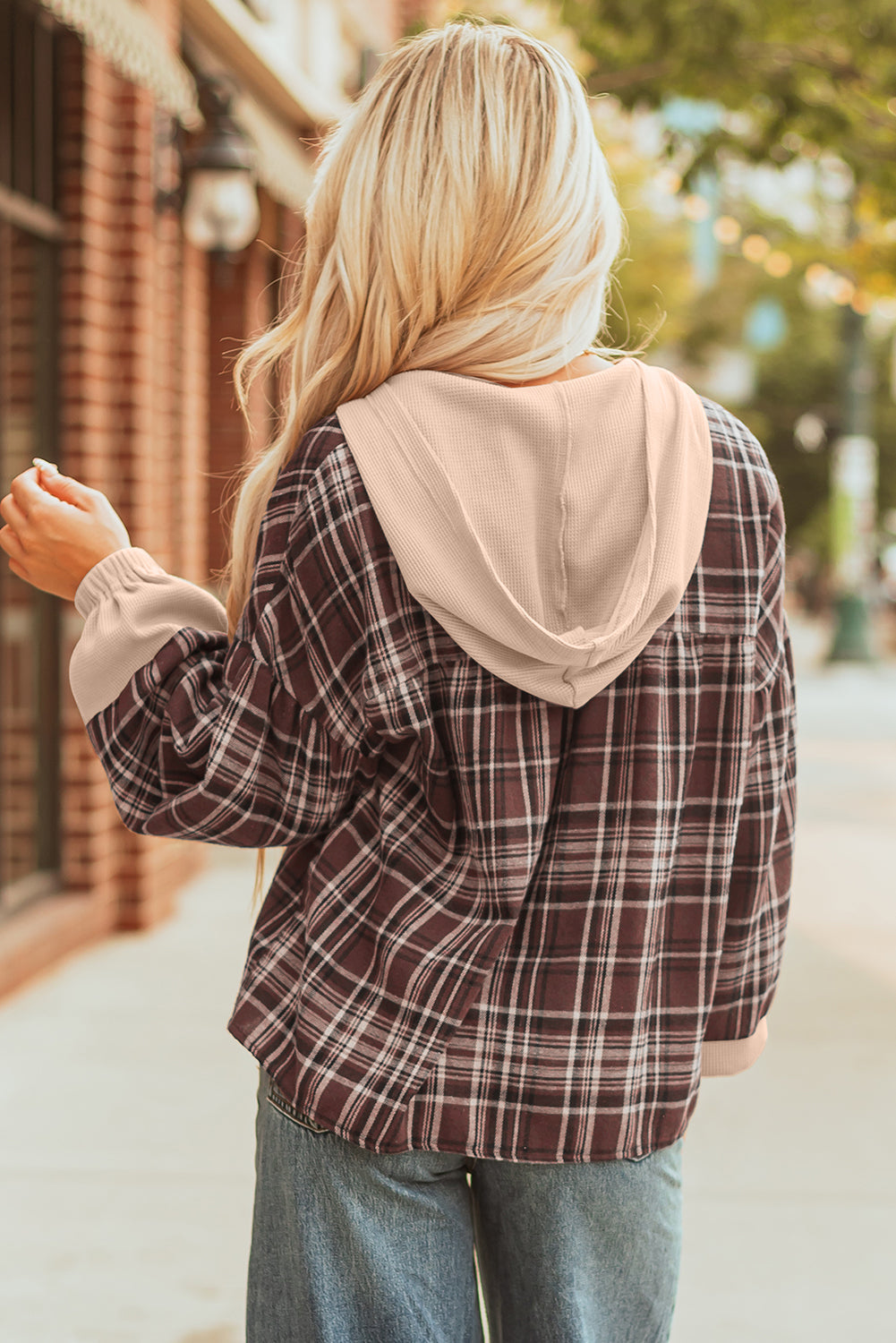 Back of the brown plaid top showing the beige waffle knit hood