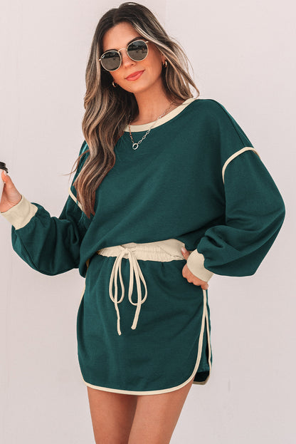 Evergreen skort set worn with sunglasses, model holding a coffee cup