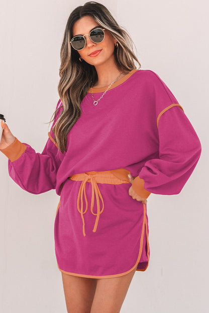 Rose red pullover and skort set with cream piping on a model