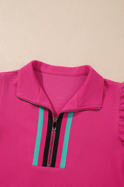 Close-up of the striped trim along the hot pink zip collar