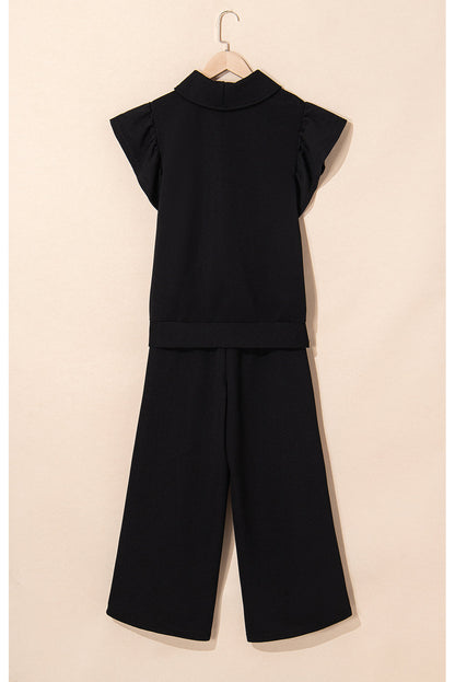 Black quarter-zip top and wide-leg pants on a hanger, back view