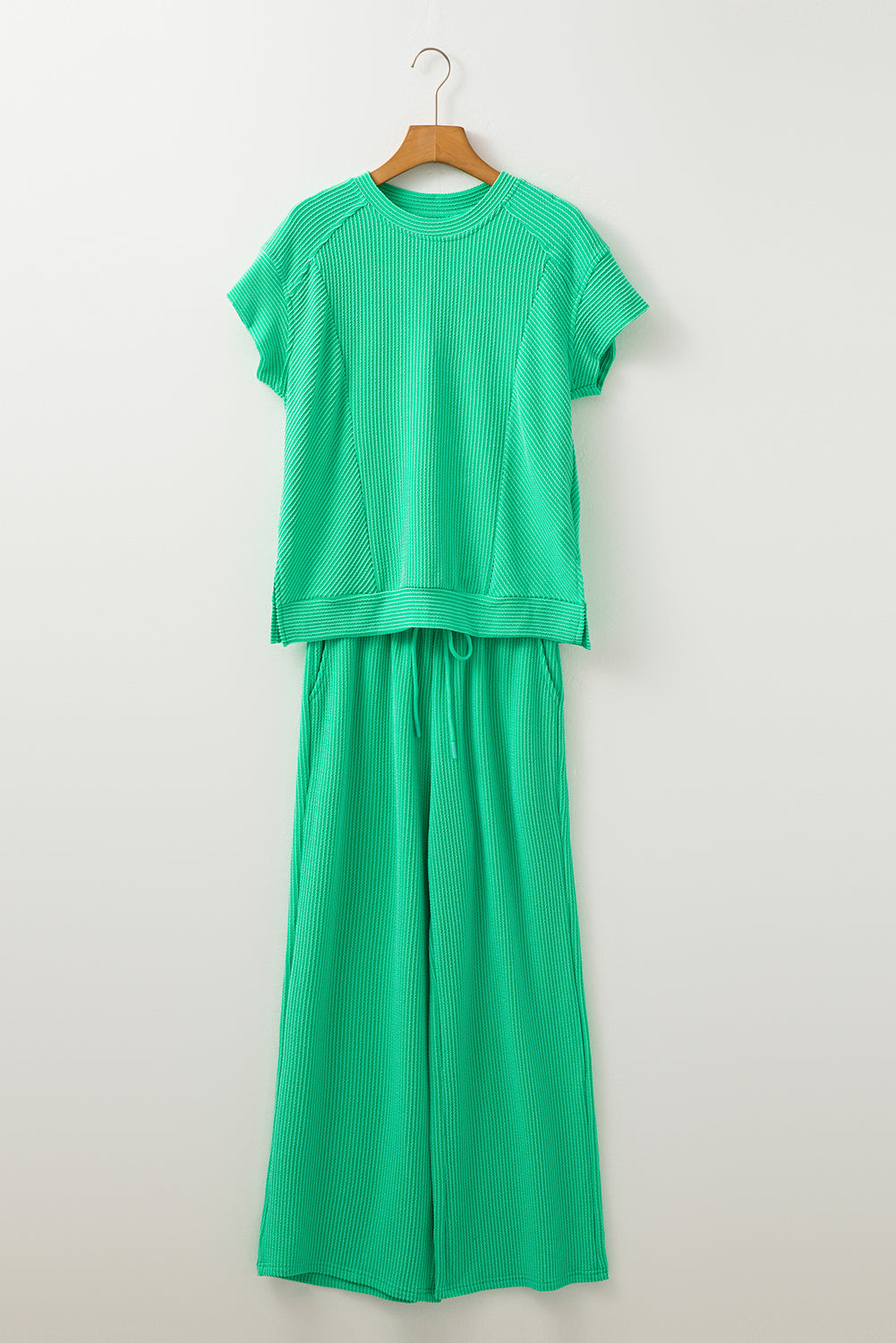 Bright green ribbed knit tee and wide-leg pants set on a hanger