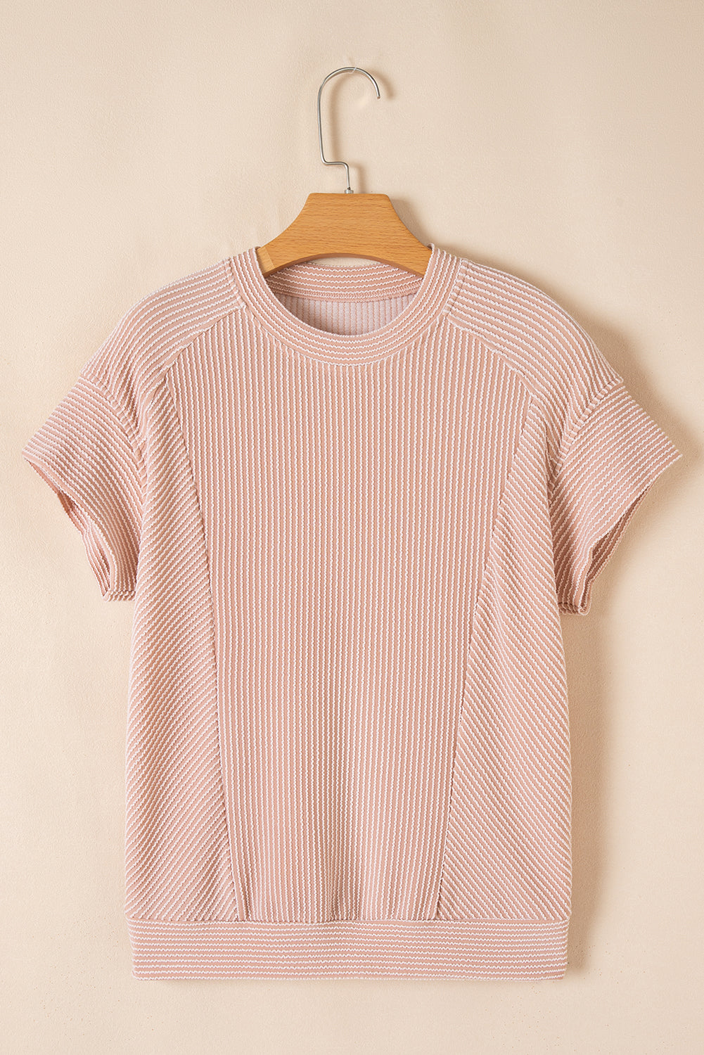 Blush pink ribbed knit tee on a hanger