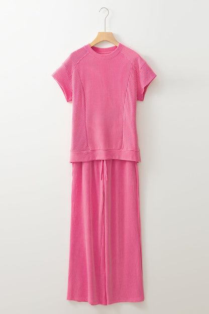 Bright pink ribbed knit tee and wide-leg pants set on a hanger