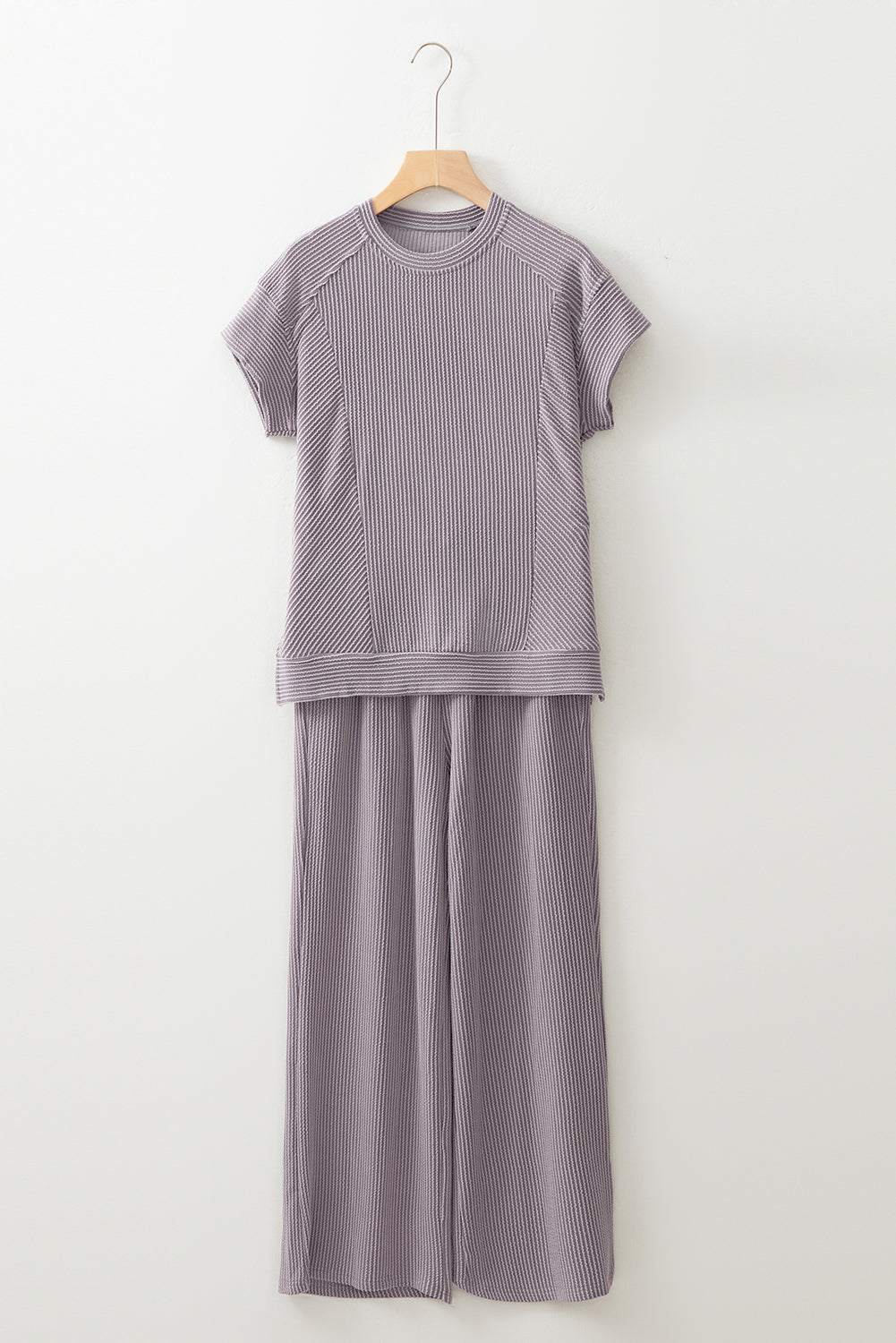Gray ribbed knit tee and wide-leg pants set on a hanger