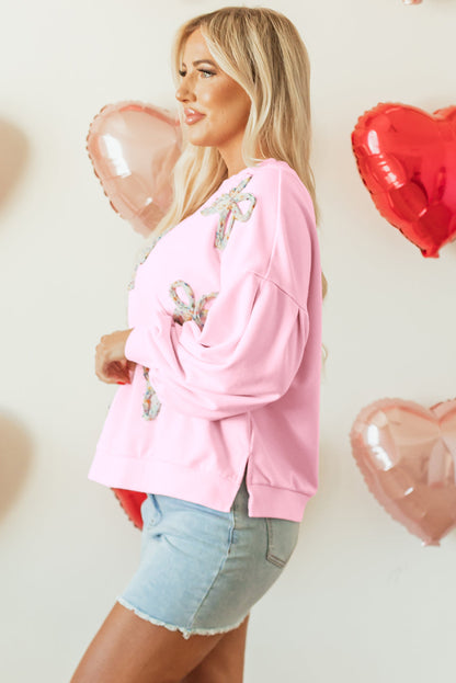 Side view of the light pink sequin bow sweatshirt