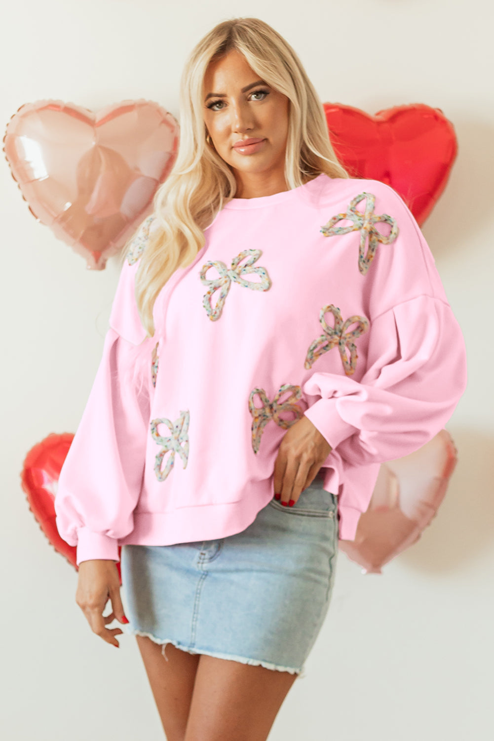 Light pink oversized sweatshirt with sequin bows, front view