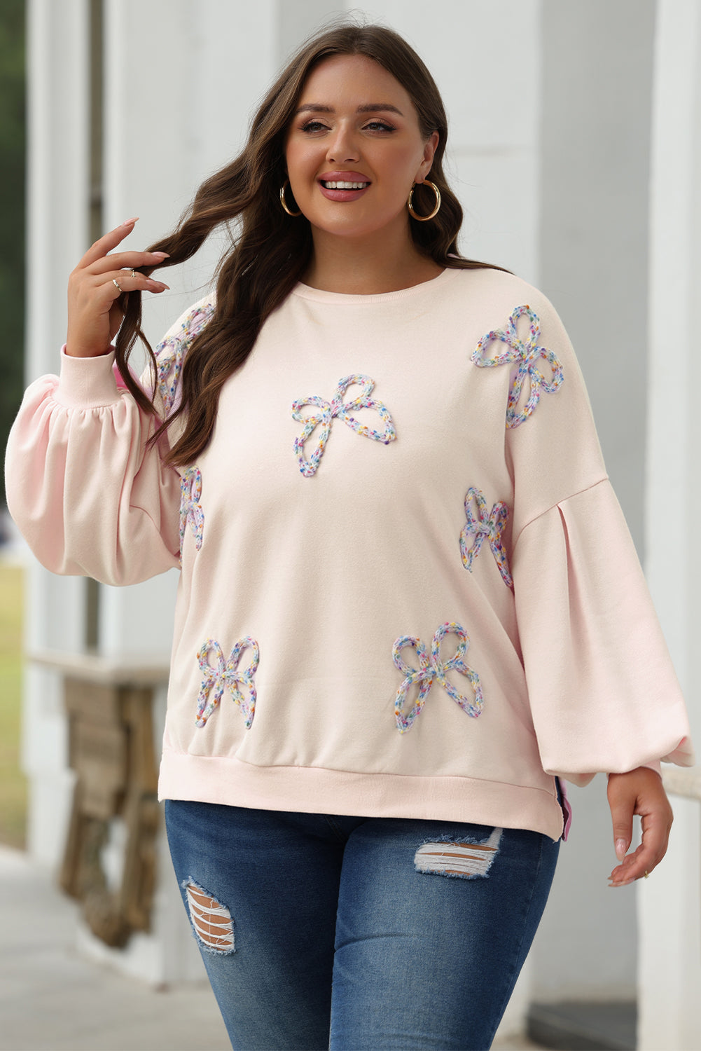 Cream sequin bow sweatshirt with lantern sleeves, worn with jeans