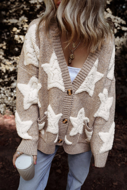 Khaki sherpa star cardigan buttoned over jeans, front view, model holding a coffee cup