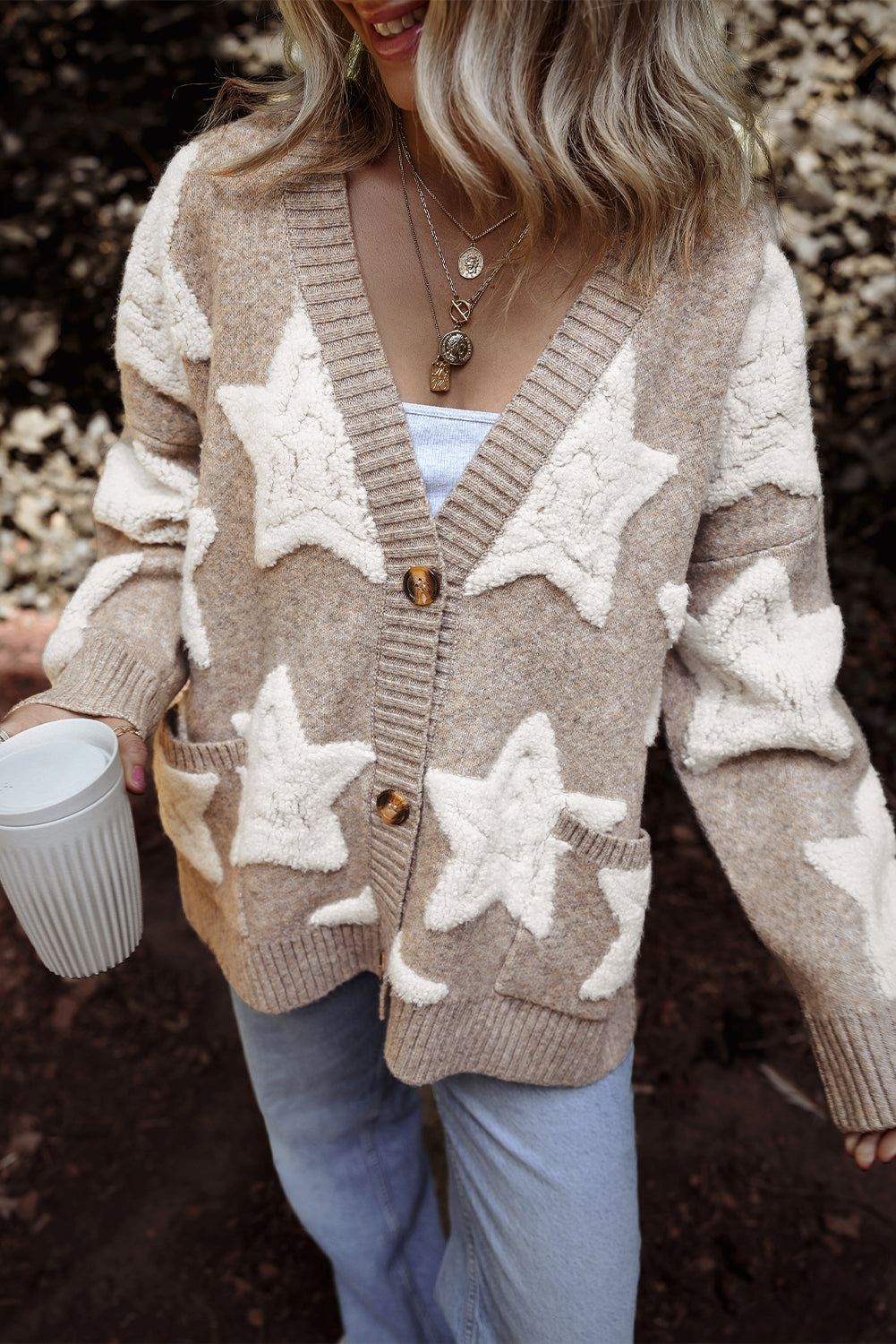 Three-quarter view of the khaki star cardigan with a V-neck and wooden-look buttons