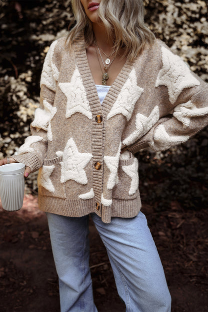 Side view of the khaki star cardigan, hand tucked into the front pocket