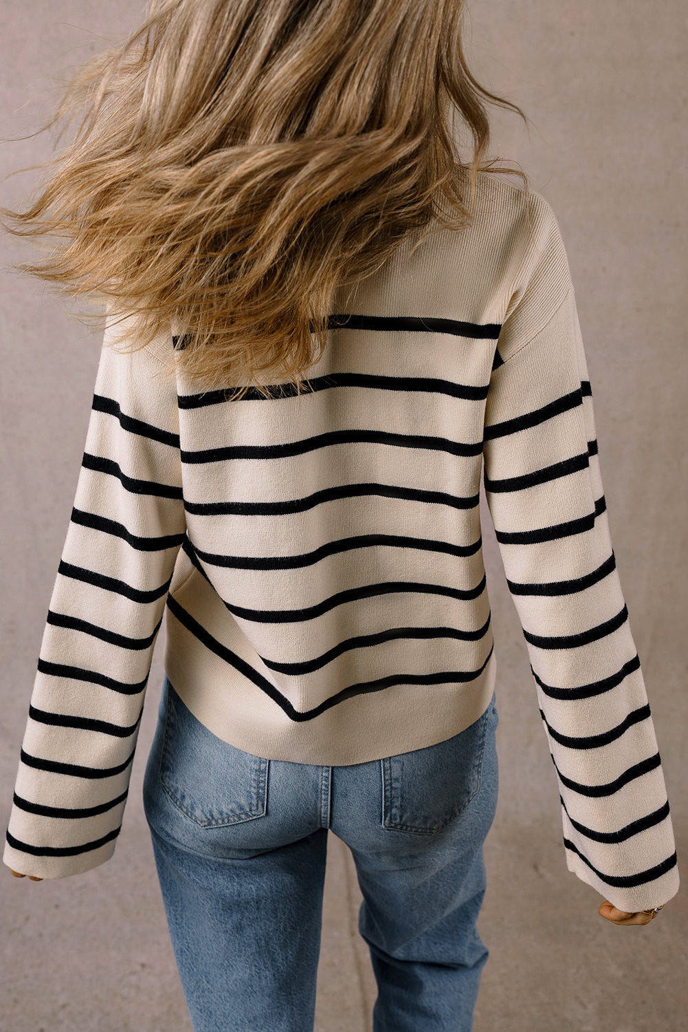 Back view of the cream and black striped cardigan