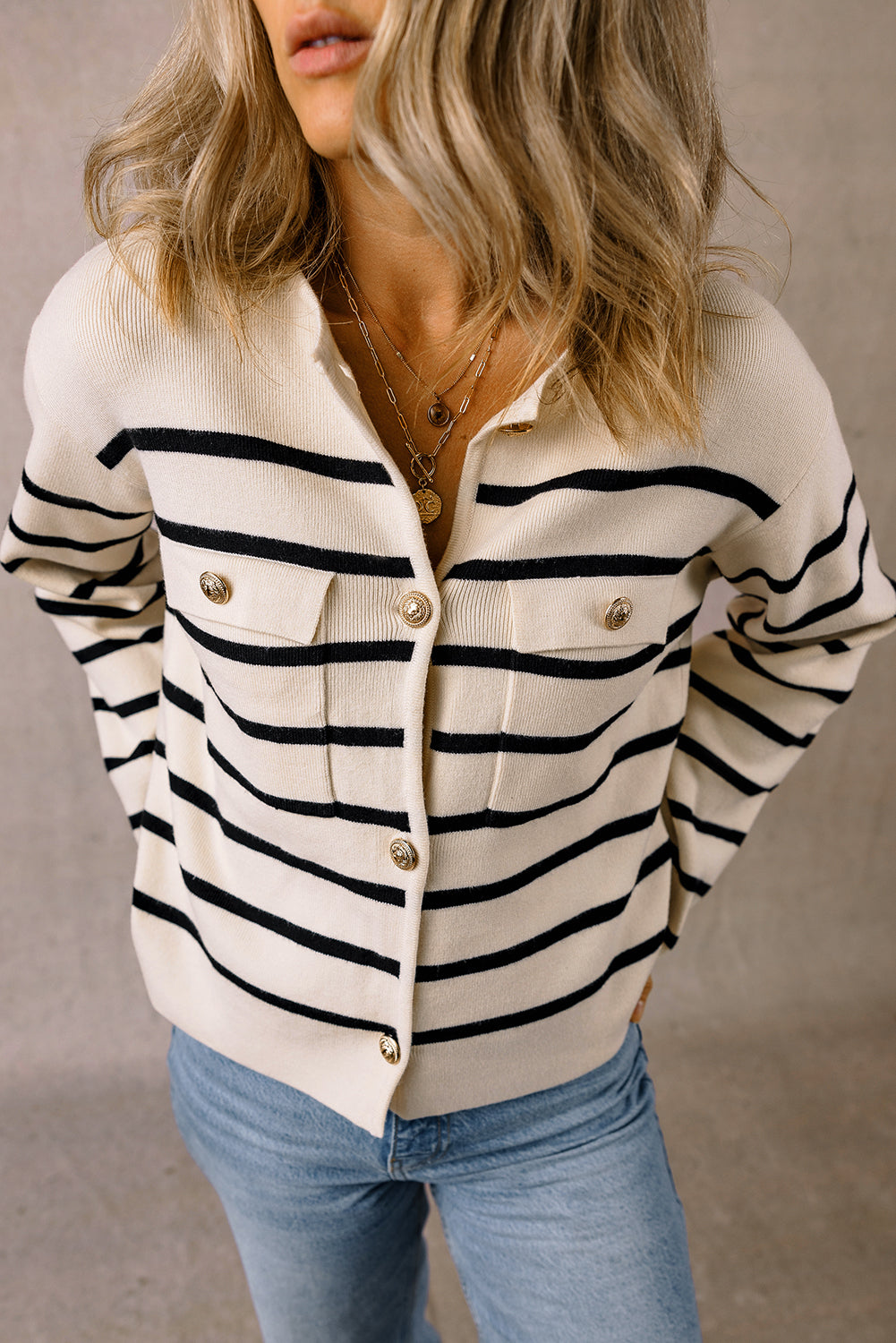 Close front view of the gold buttons and flap pockets