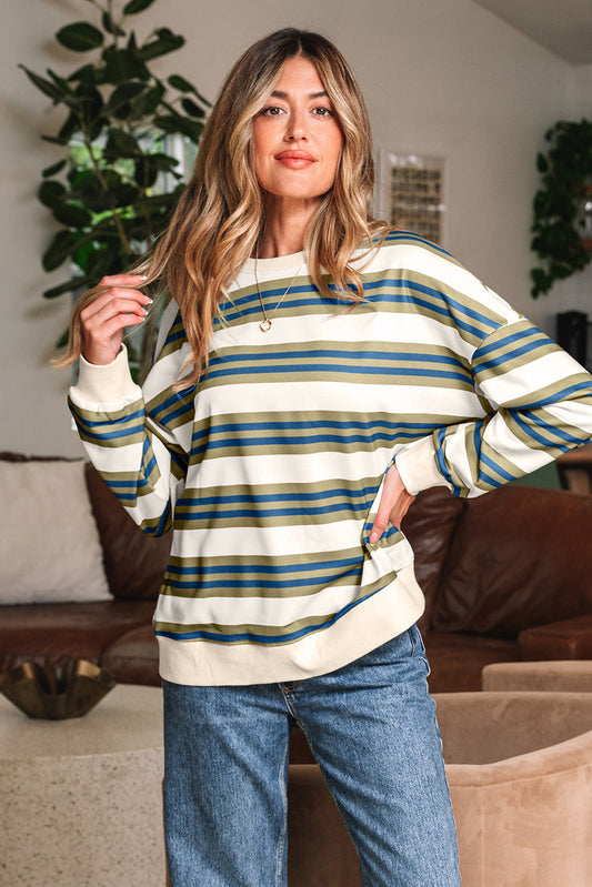 Cream sweatshirt with teal, olive and navy stripes, hand in hair